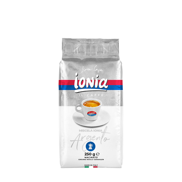 Eine silber weiße Vakuumverpackung für den gemahlenen Mokka Kaffee Ionia Argento. In der Mitte ist eine dickwandige weiße Espressotasse mit dem Ionia Logo abgebildet. Sie ist fast voll gefüllt mit Espresso mit dichter Crema. Darüber sieht man den weißen Ionia Schriftzug auf rot/blauem Hintergrund. Unterhalb ist der Schriftzug Argento in silberner Schreibschrift angebracht.