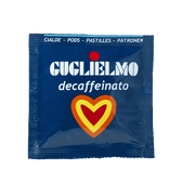 Eine blaue Aromaverpackung für den koffeinfreien Kaffee Guglielmo Dek als E.S.E. Pad. In der Mitte befindet sich ein Herz in den Farben orange, gelb und rot.