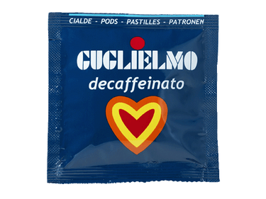 Eine blaue Aromaverpackung für den koffeinfreien Kaffee Guglielmo Dek als E.S.E. Pad. In der Mitte befindet sich ein Herz in den Farben orange, gelb und rot.