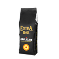 Eine schwarze Aromaverpackung für den Kaffee Guglielmo Extra Bar in Bohnen.  Oben ist der große goldene Schriftzug Extra Bar zu lesen, darunter der Schriftzug Guglielmo il caffè che fa centro. Unten sieht man das Logo mit dem orange, gelb, roten konzentrischen Kreis.